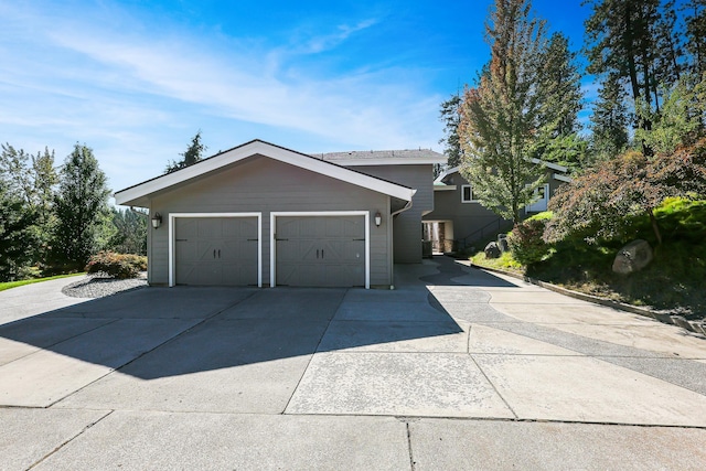 exterior space with an attached garage and concrete driveway