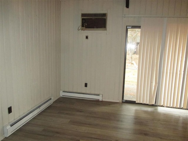 6311 E 6th Ave, Spokane Valley, WA 99212 - empty room with a wall unit AC, a baseboard radiator, and dark wood-style flooring