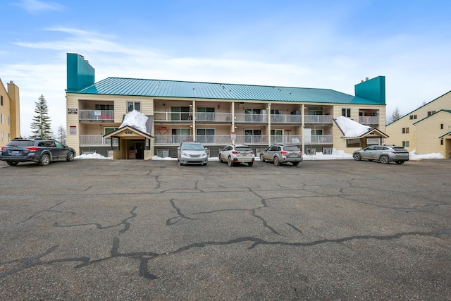 view of building exterior with uncovered parking