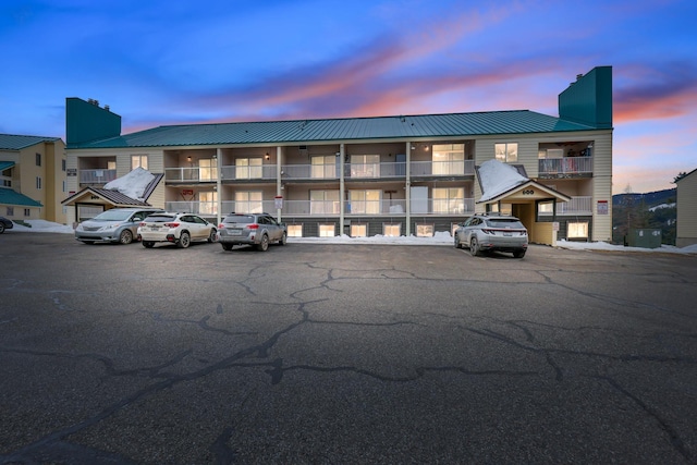 view of property featuring uncovered parking