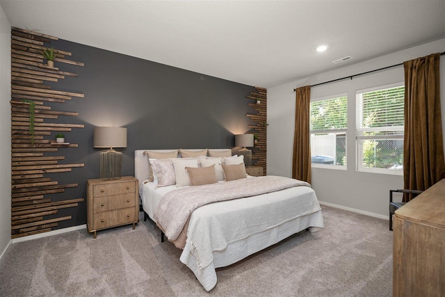 carpeted bedroom with baseboards and visible vents