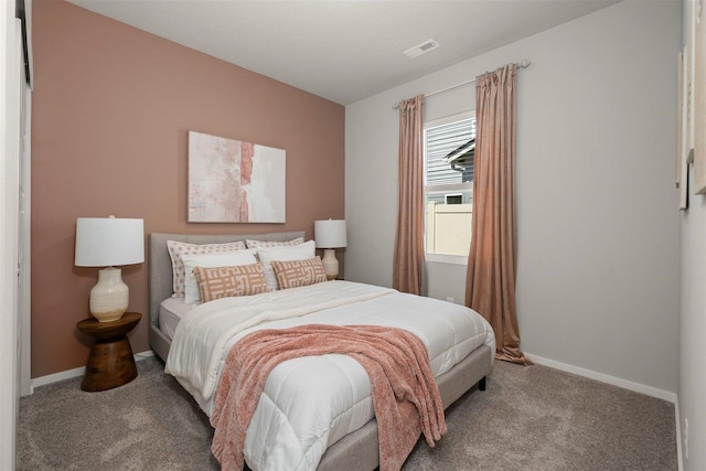 carpeted bedroom featuring visible vents and baseboards