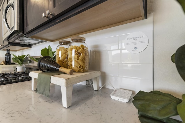 room details with appliances with stainless steel finishes, light countertops, and dark brown cabinets