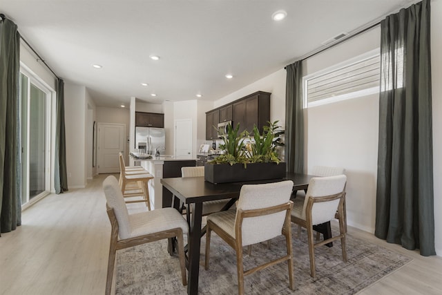 dining space with baseboards, recessed lighting, and light wood-style floors