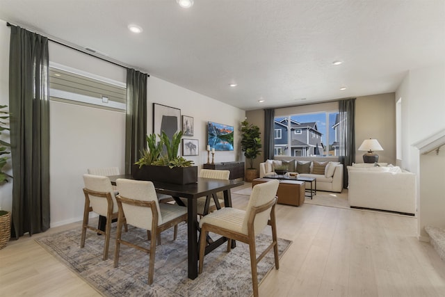 dining area with light wood-style flooring and recessed lighting