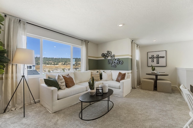 living room featuring recessed lighting, carpet flooring, and a textured ceiling