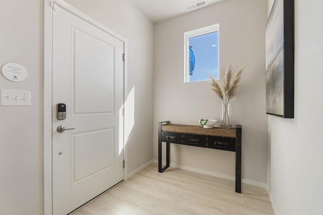 entrance foyer with light wood-style flooring, visible vents, and baseboards