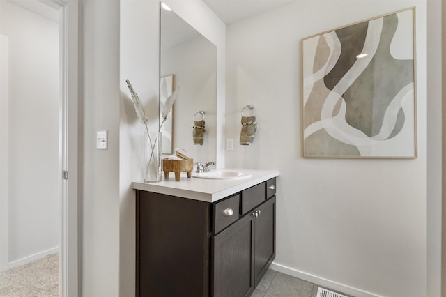 bathroom featuring vanity, baseboards, and tile patterned floors