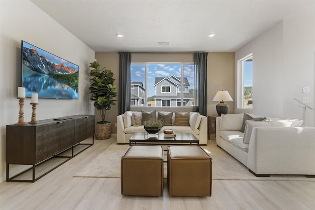 living area featuring wood finished floors, visible vents, and recessed lighting