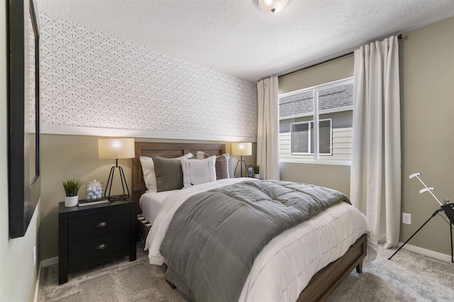 bedroom with light carpet, wallpapered walls, baseboards, and a textured ceiling