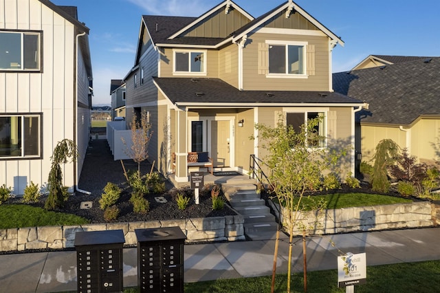 view of front facade featuring roof with shingles and board and batten siding