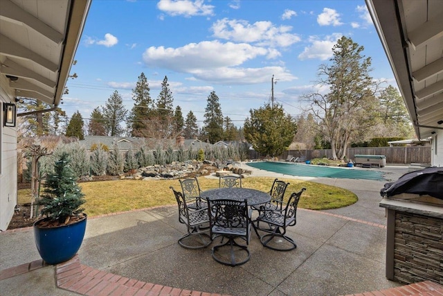 view of patio / terrace with a fenced backyard, outdoor dining area, and a fenced in pool