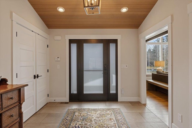 entrance foyer with vaulted ceiling, wood ceiling, and recessed lighting