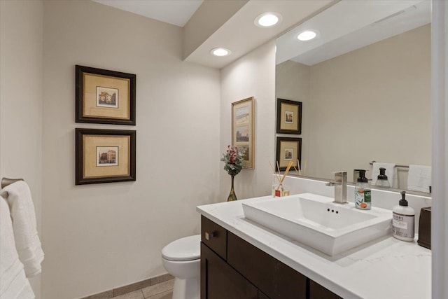 half bath featuring toilet, tile patterned flooring, recessed lighting, and vanity