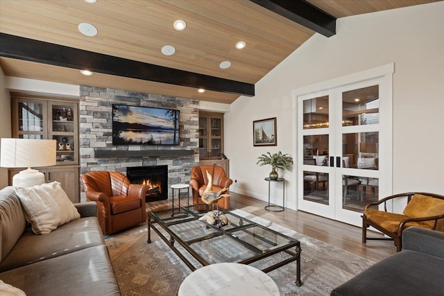 living room with a fireplace, recessed lighting, lofted ceiling with beams, wood finished floors, and baseboards