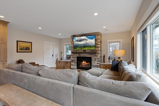 living room featuring recessed lighting and a fireplace