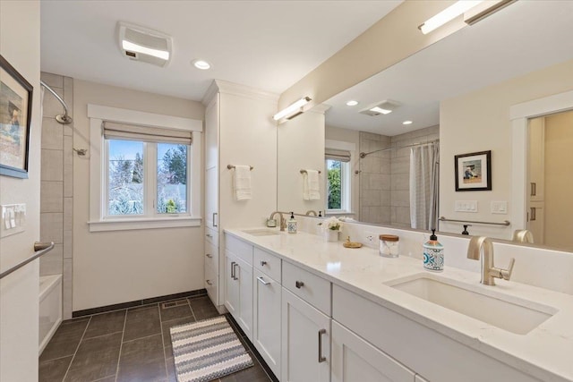 full bath with a sink, visible vents, and recessed lighting