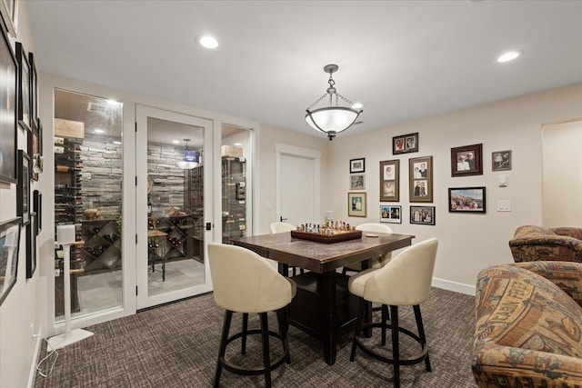 dining area with baseboards, dark colored carpet, and recessed lighting