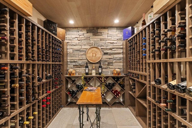 wine cellar with recessed lighting and wood ceiling