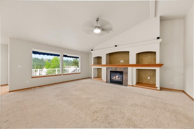 711 W Bolan Ave, Spokane, WA 99224 - unfurnished living room featuring vaulted ceiling, a fireplace, a ceiling fan, carpet flooring, and baseboards