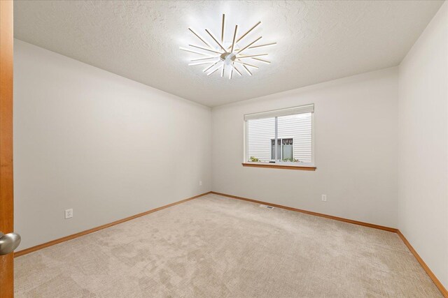 711 W Bolan Ave, Spokane, WA 99224 - carpeted spare room with baseboards and a textured ceiling