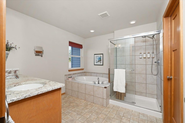 711 W Bolan Ave, Spokane, WA 99224 - bathroom featuring a garden tub, a shower stall, tile patterned floors, double vanity, and recessed lighting