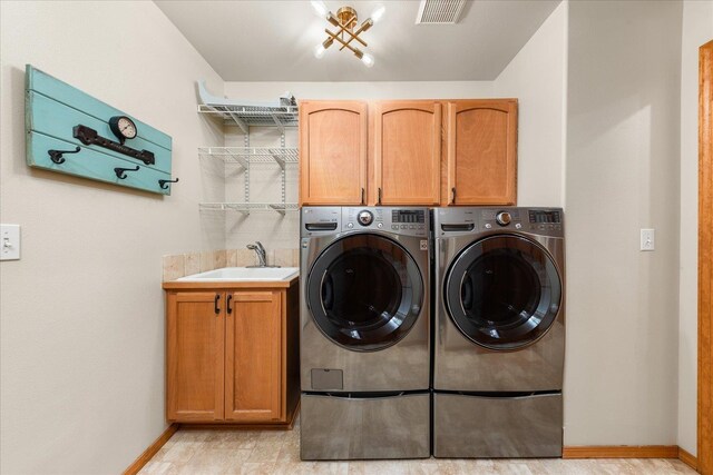 711 W Bolan Ave, Spokane, WA 99224 - laundry area featuring cabinet space, independent washer and dryer, and baseboards