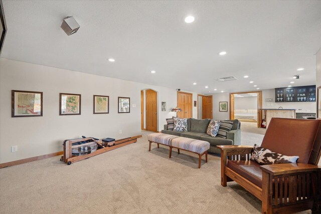 living room with light carpet, baseboards, and recessed lighting