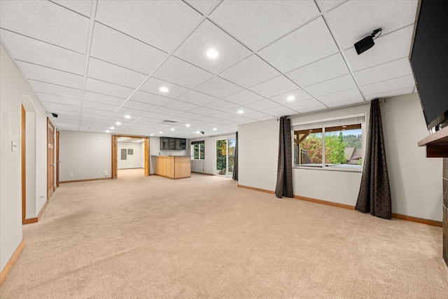 711 W Bolan Ave, Spokane, WA 99224 - unfurnished living room with light colored carpet, baseboards, recessed lighting, healthy amount of natural light, and a paneled ceiling