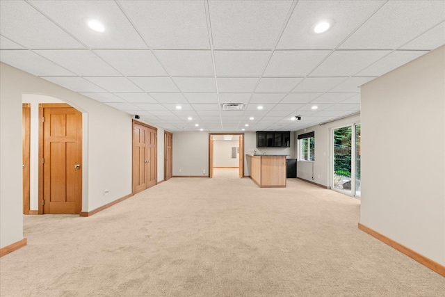 711 W Bolan Ave, Spokane, WA 99224 - unfurnished living room with light carpet, baseboards, arched walkways, recessed lighting, and a paneled ceiling
