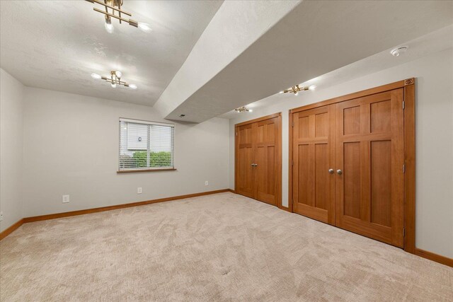 711 W Bolan Ave, Spokane, WA 99224 - unfurnished bedroom featuring two closets, baseboards, and light carpet