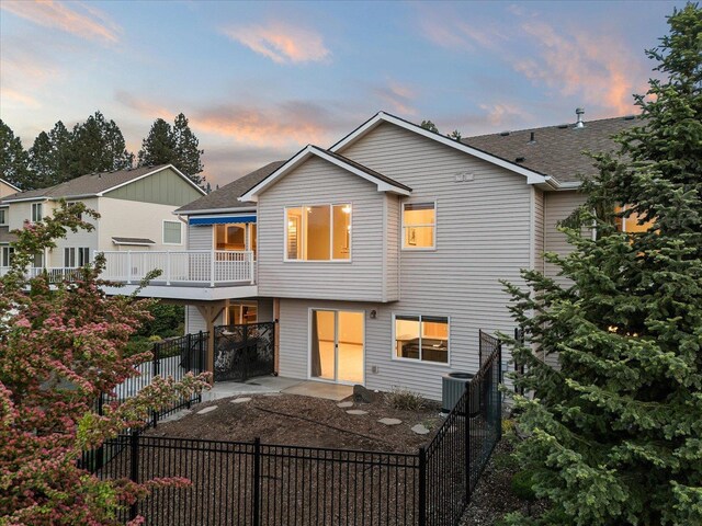 711 W Bolan Ave, Spokane, WA 99224 - view of front of house featuring a patio, central AC, a fenced backyard, and roof with shingles
