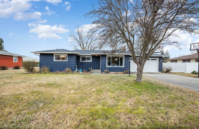 single story home with an attached garage, driveway, fence, and a front yard