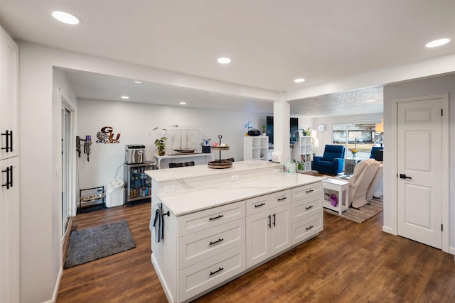 kitchen featuring baseboards, white cabinets, open floor plan, dark wood-style flooring, and recessed lighting