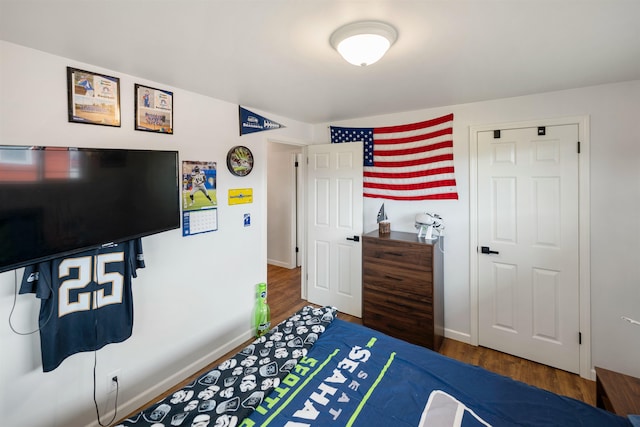 bedroom featuring wood finished floors and baseboards