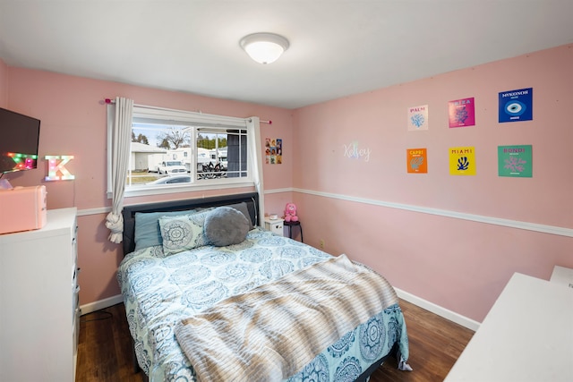 bedroom featuring baseboards and wood finished floors