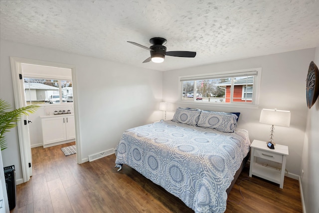 bedroom featuring baseboards, visible vents, a ceiling fan, hardwood / wood-style floors, and a textured ceiling