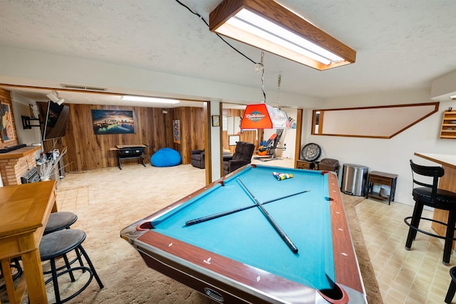 playroom with visible vents, pool table, carpet flooring, wooden walls, and a textured ceiling