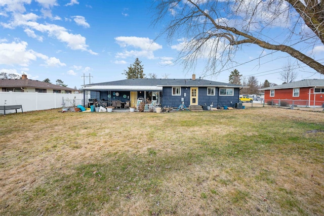 back of property featuring entry steps, a fenced backyard, a lawn, and a patio