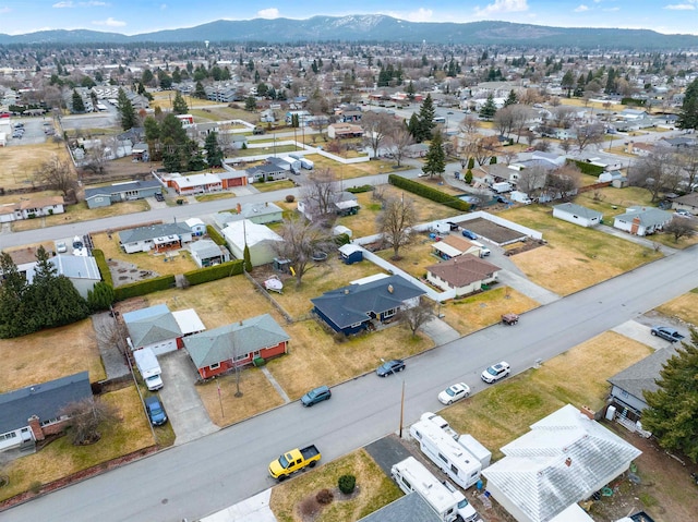 drone / aerial view featuring a residential view and a mountain view