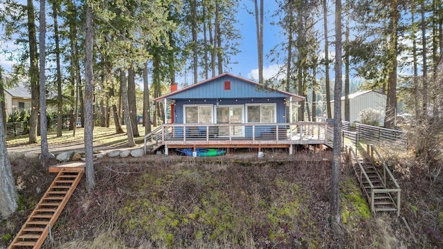 rear view of house featuring stairway and a wooden deck