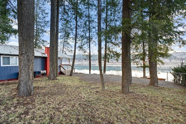 view of yard featuring a water view and fence