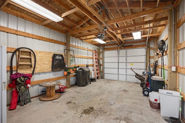 garage with a garage door opener and metal wall