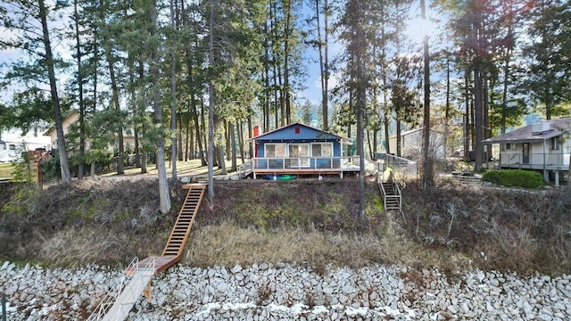 back of house with stairs and a wooden deck