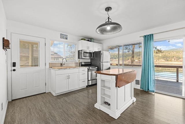 kitchen with dark wood-style flooring, a sink, white cabinetry, appliances with stainless steel finishes, and open shelves