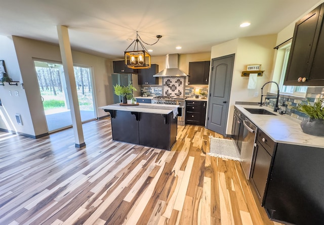 22410 S Ritchey Rd, Cheney, WA 99004 - kitchen featuring a sink, wall chimney exhaust hood, stainless steel appliances, tasteful backsplash, and recessed lighting
