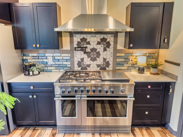 22410 S Ritchey Rd, Cheney, WA 99004 - kitchen with double oven range, wall chimney range hood, backsplash, light stone countertops, and light wood-style flooring