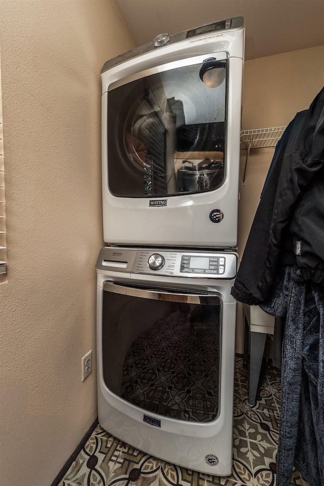 laundry room with stacked washer / dryer