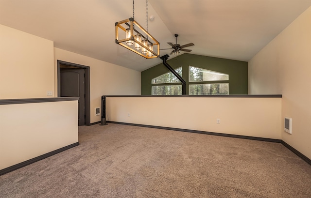unfurnished room with carpet flooring, ceiling fan, baseboards, lofted ceiling, and visible vents