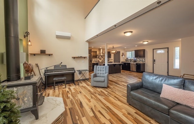 living room featuring a notable chandelier and light wood-type flooring